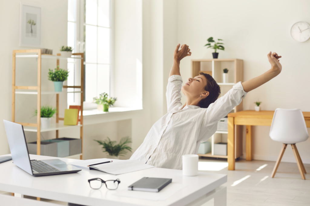 woman stretching at her desk